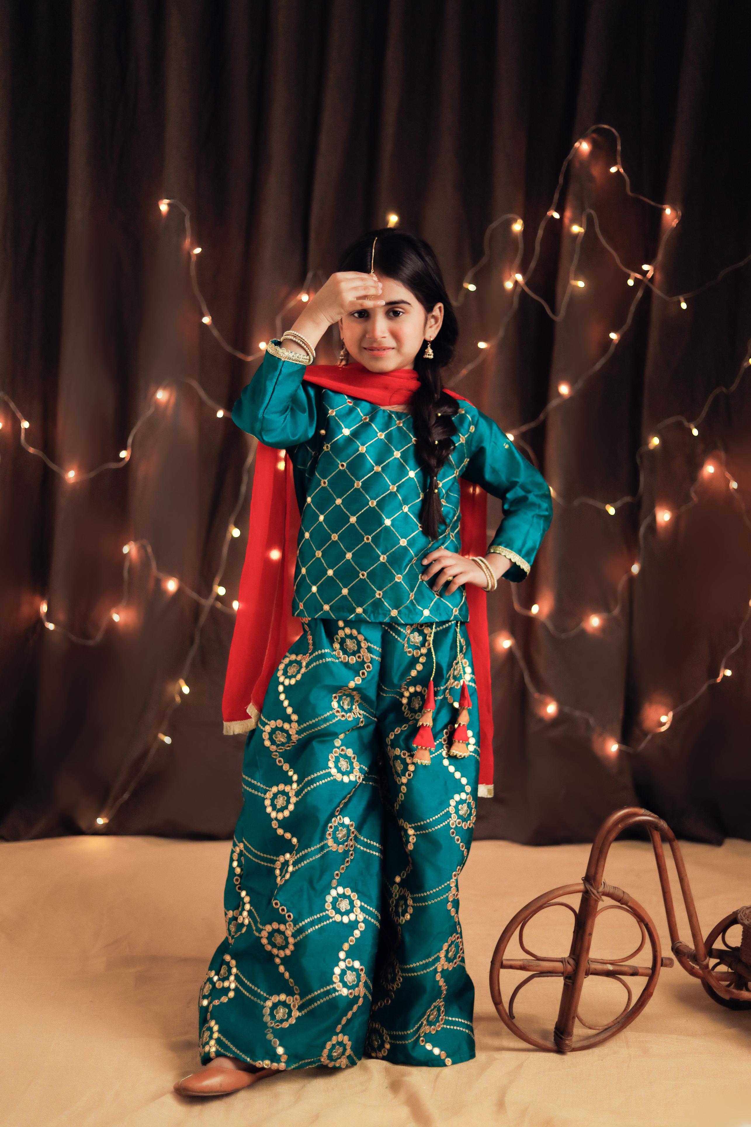 Teal colored plazo and short shirt with golden embroidery and pink contrast dupatta